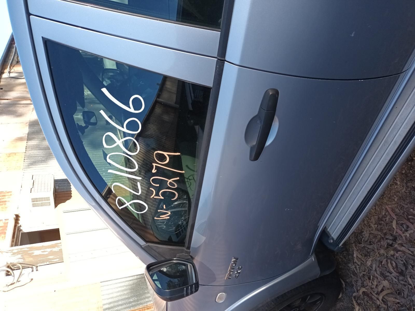 A Silver Car with a Numbers on the Window — South West 4WD Wreckers In Brisbane, QLD