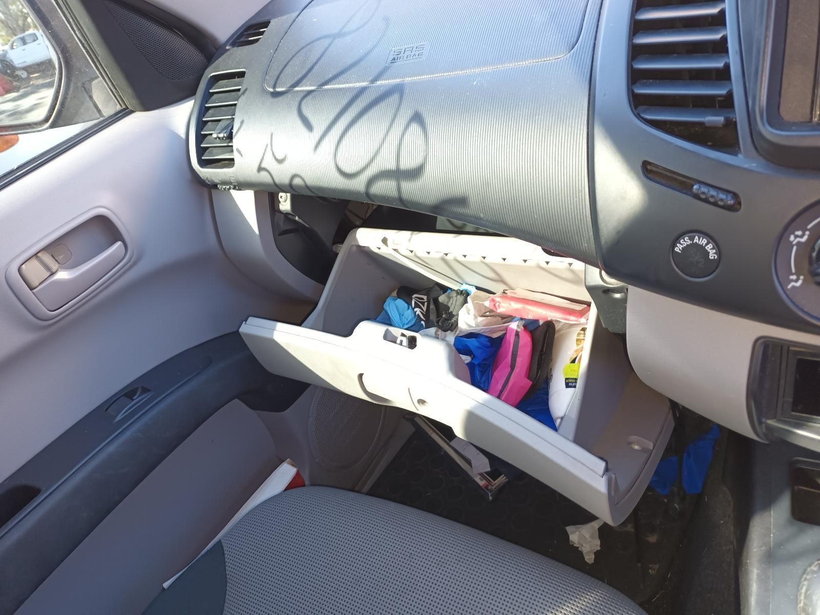 The Glove Box of a Car is Open and Filled with Various Items — South West 4WD Wreckers In Brisbane, QLD