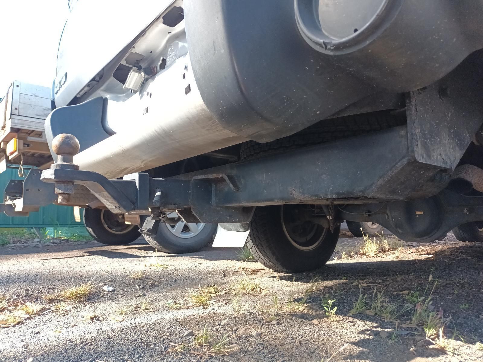 A Truck with a Trailer Attached to It is Parked on the Side of the Road — South West 4WD Wreckers In Brisbane, QLD