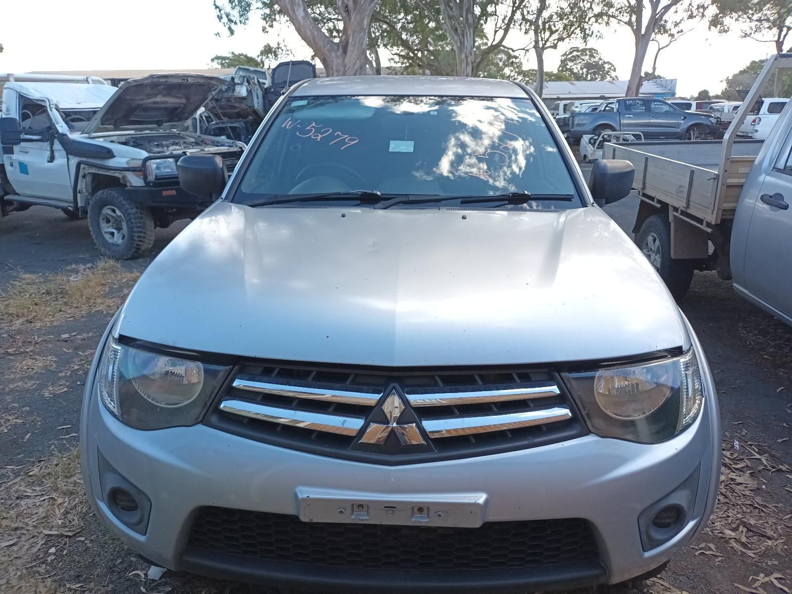 A Silver Mitsubishi Triton is Parked in a Lot — South West 4WD Wreckers In Brisbane, QLD