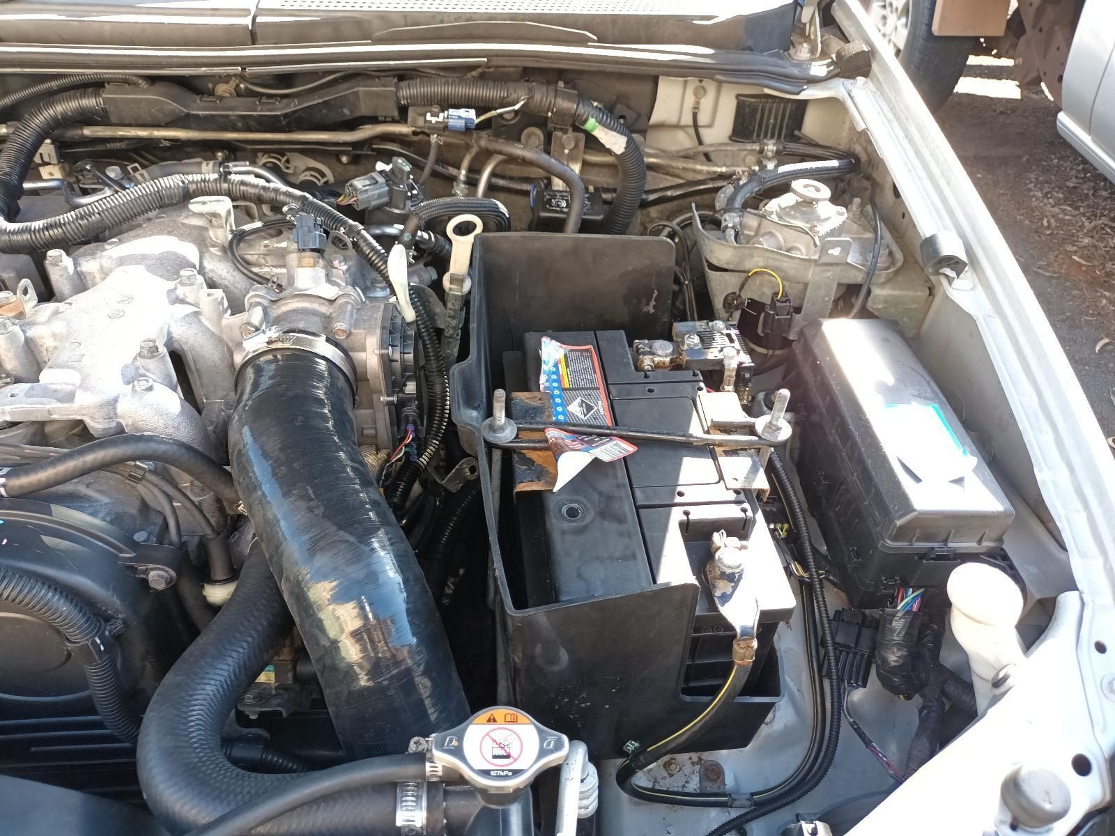 The Engine of a Car is Shown with the Battery Removed — South West 4WD Wreckers In Brisbane, QLD