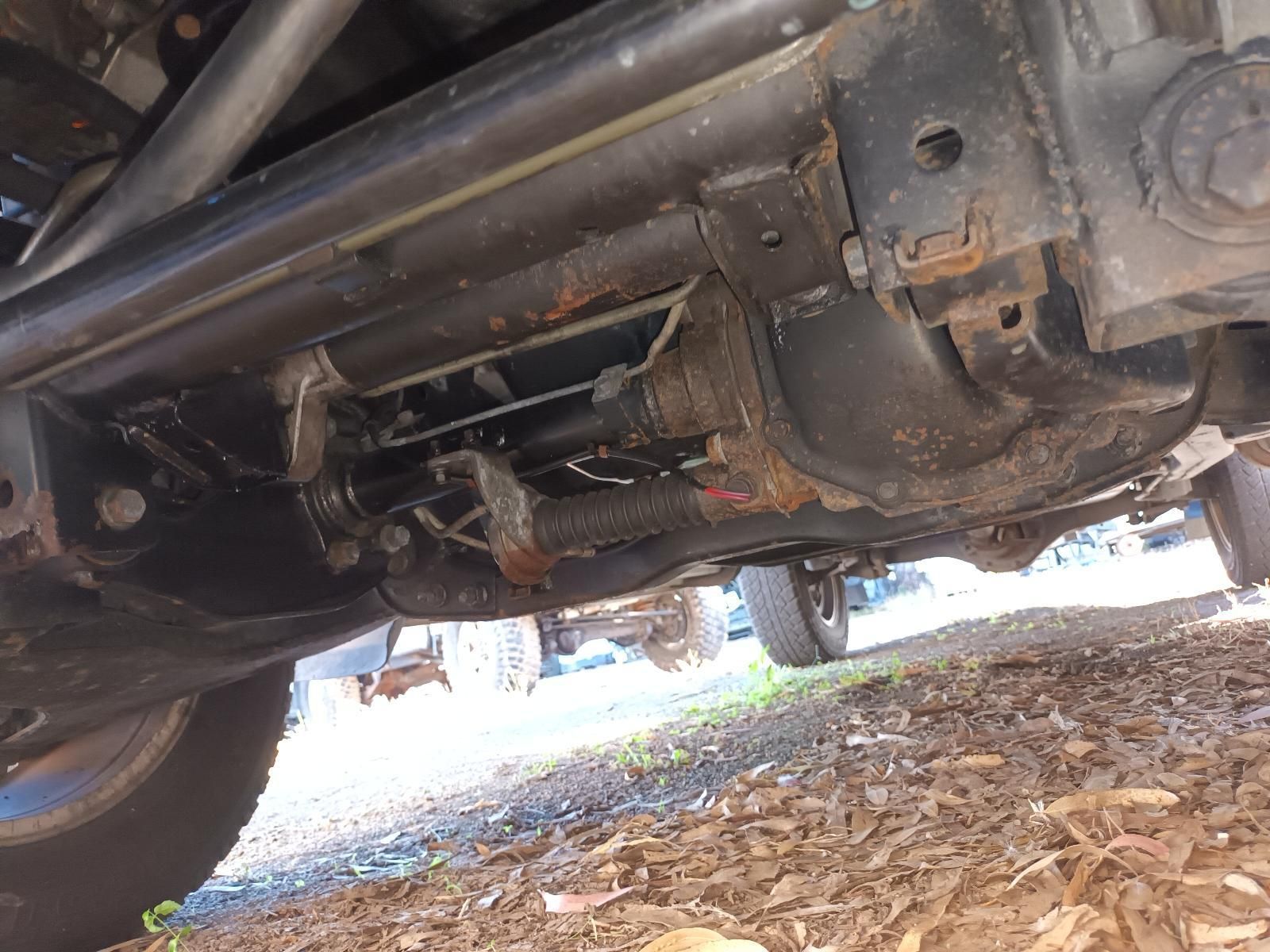 A Close Up of the Underside of a Car on a Dirt Road — South West 4WD Wreckers In Brisbane, QLD