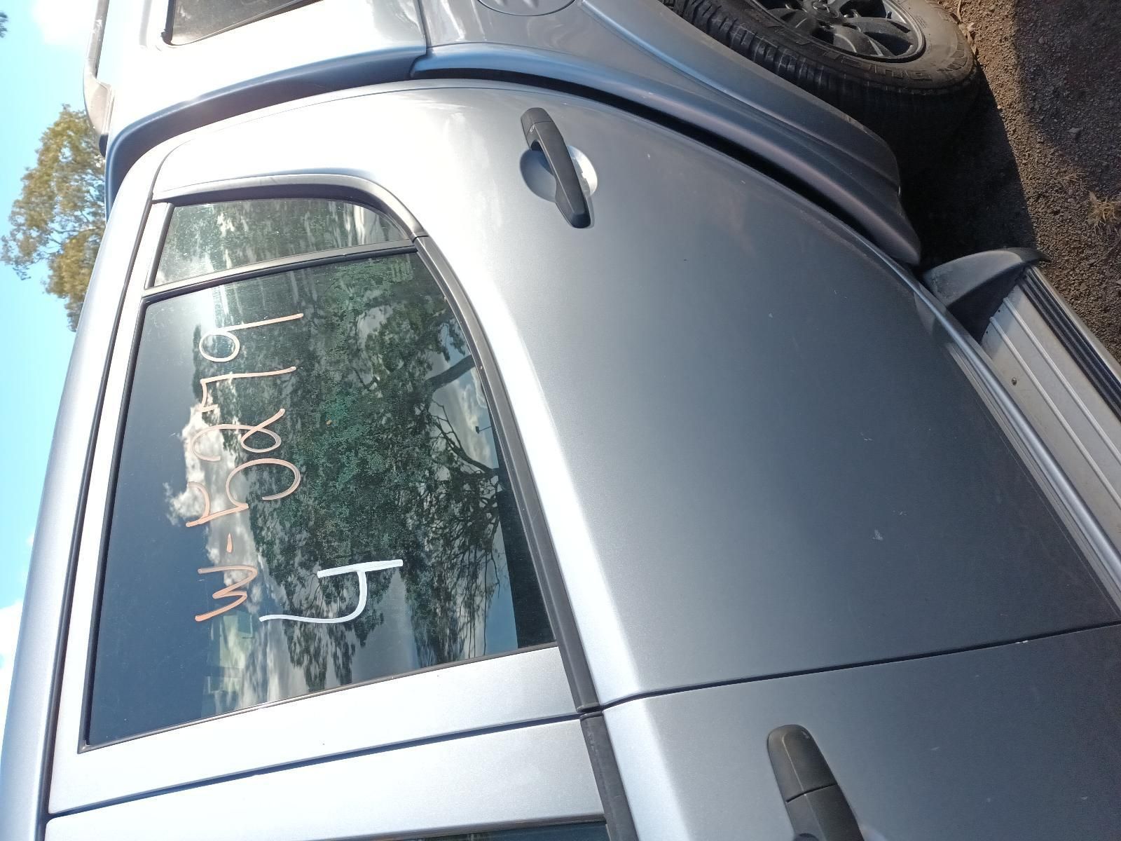 A Silver Truck is Parked on the Side of the Road — South West 4WD Wreckers In Brisbane, QLD