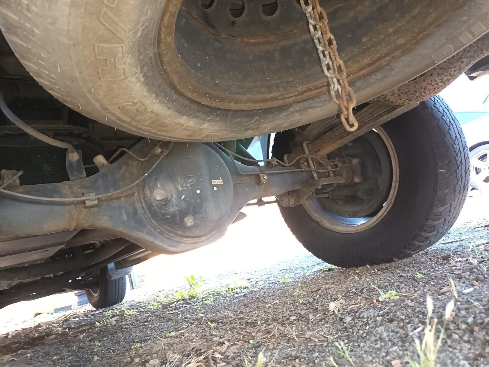 A Close Up of the Underside of a Car with a Chain Attached to It — South West 4WD Wreckers In Brisbane, QLD