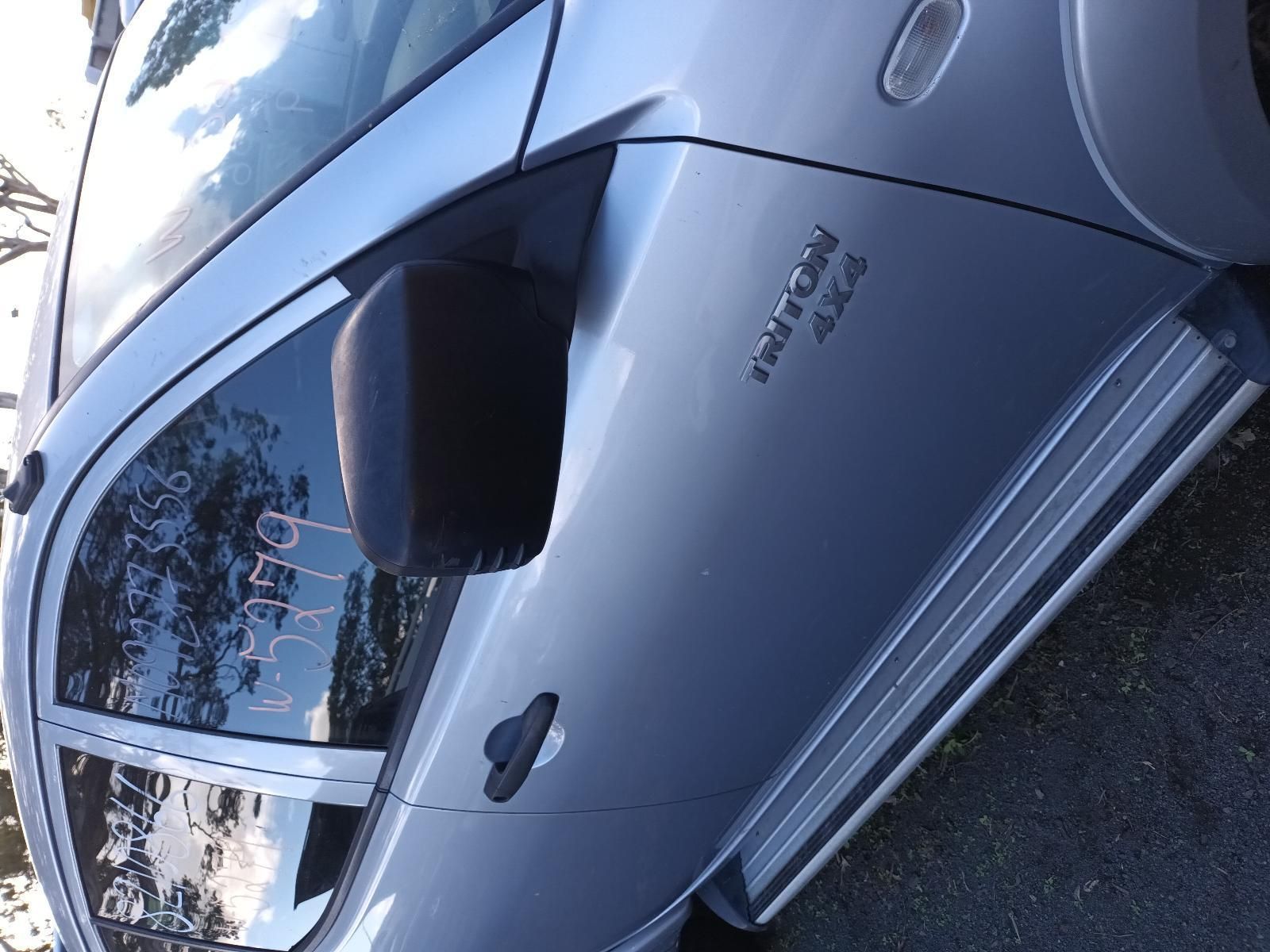 A Silver Car is Parked on the Side of the Road — South West 4WD Wreckers In Brisbane, QLD