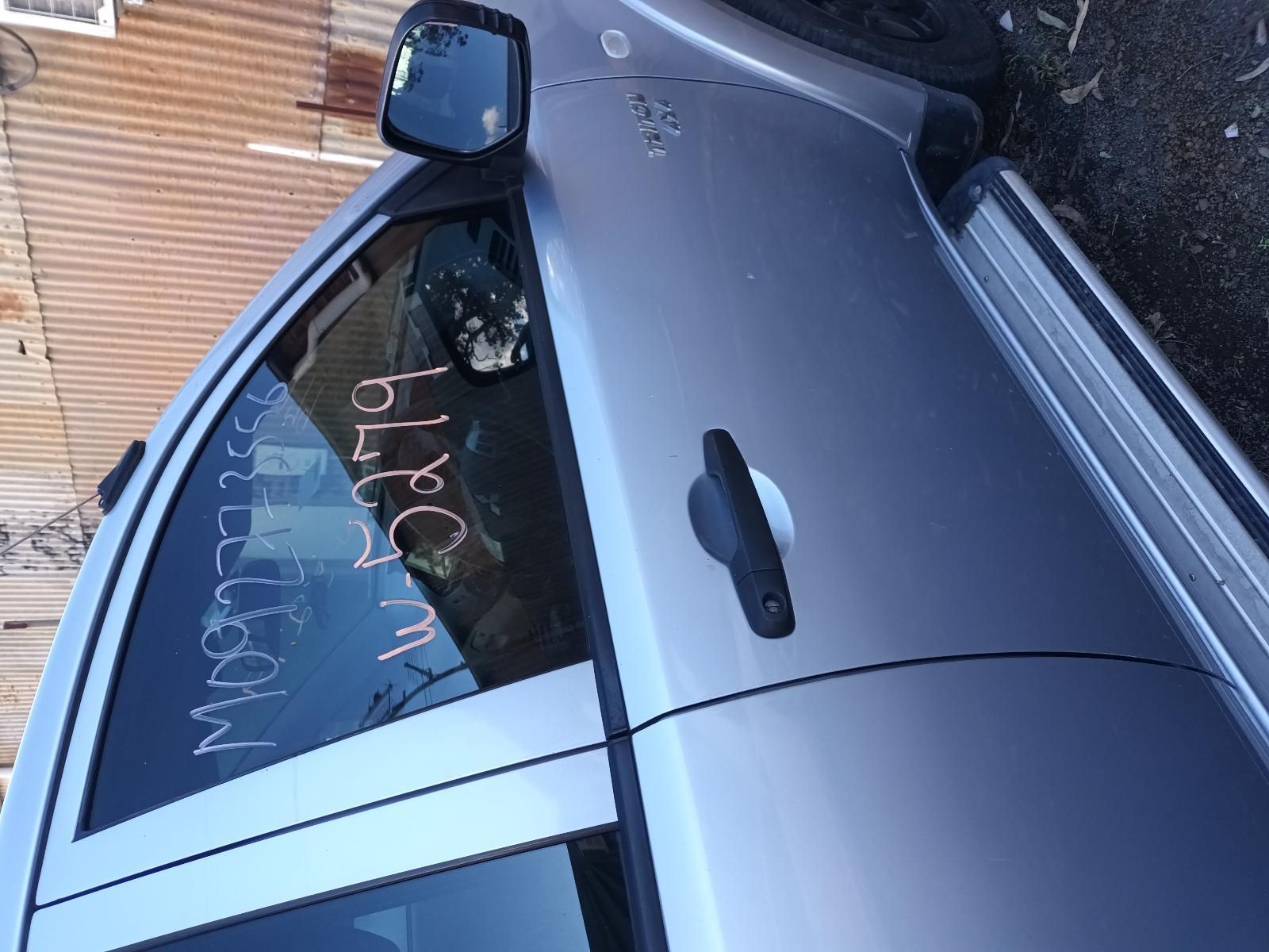 A Silver Car is Parked in Front of a Building — South West 4WD Wreckers In Brisbane, QLD