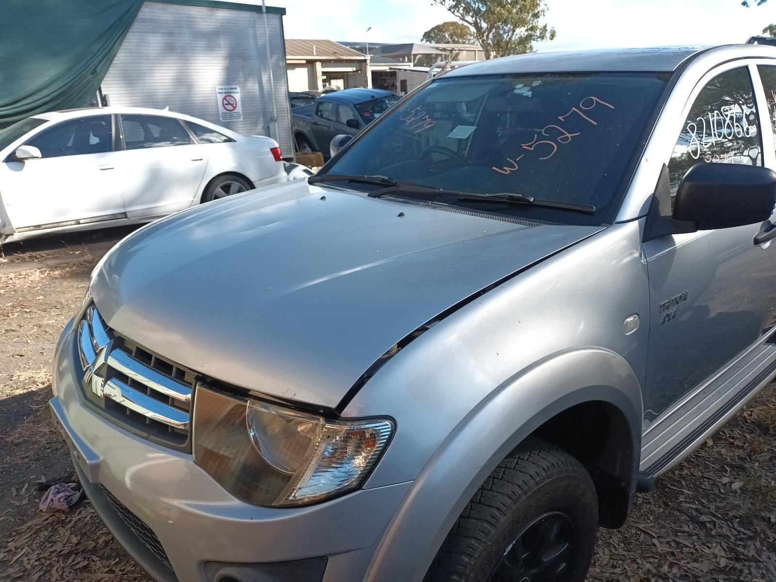 A Silver Truck is Parked in a Gravel Lot — South West 4WD Wreckers In Brisbane, QLD