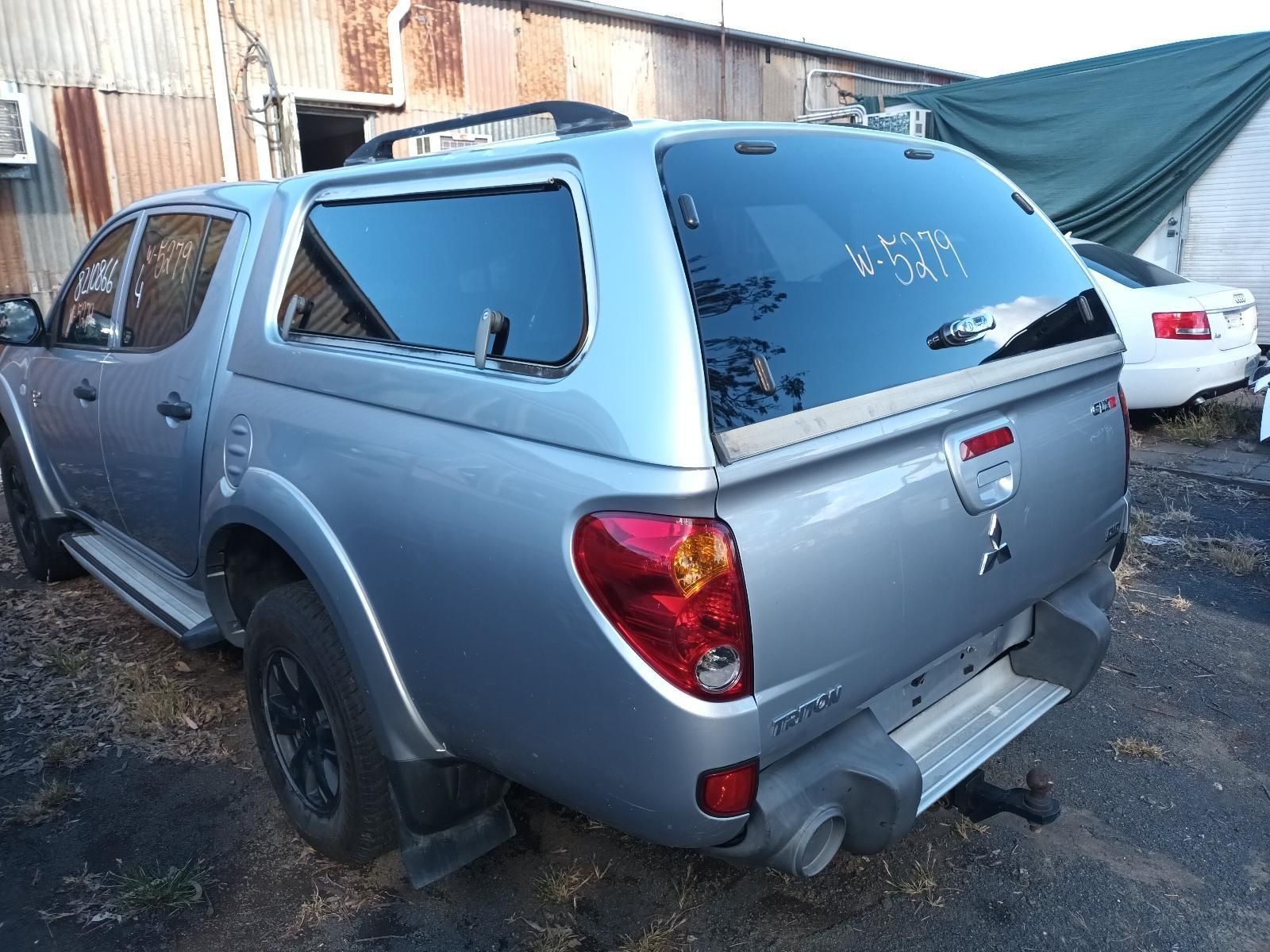 A Silver Truck with a Canopy is Parked in a Parking Lot — South West 4WD Wreckers In Brisbane, QLD