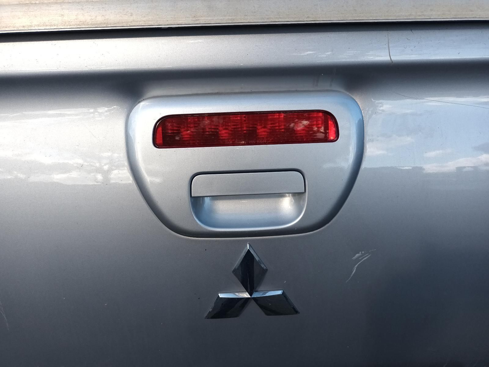 A Silver Mitsubishi Truck with a Red Tail Light — South West 4WD Wreckers In Brisbane, QLD