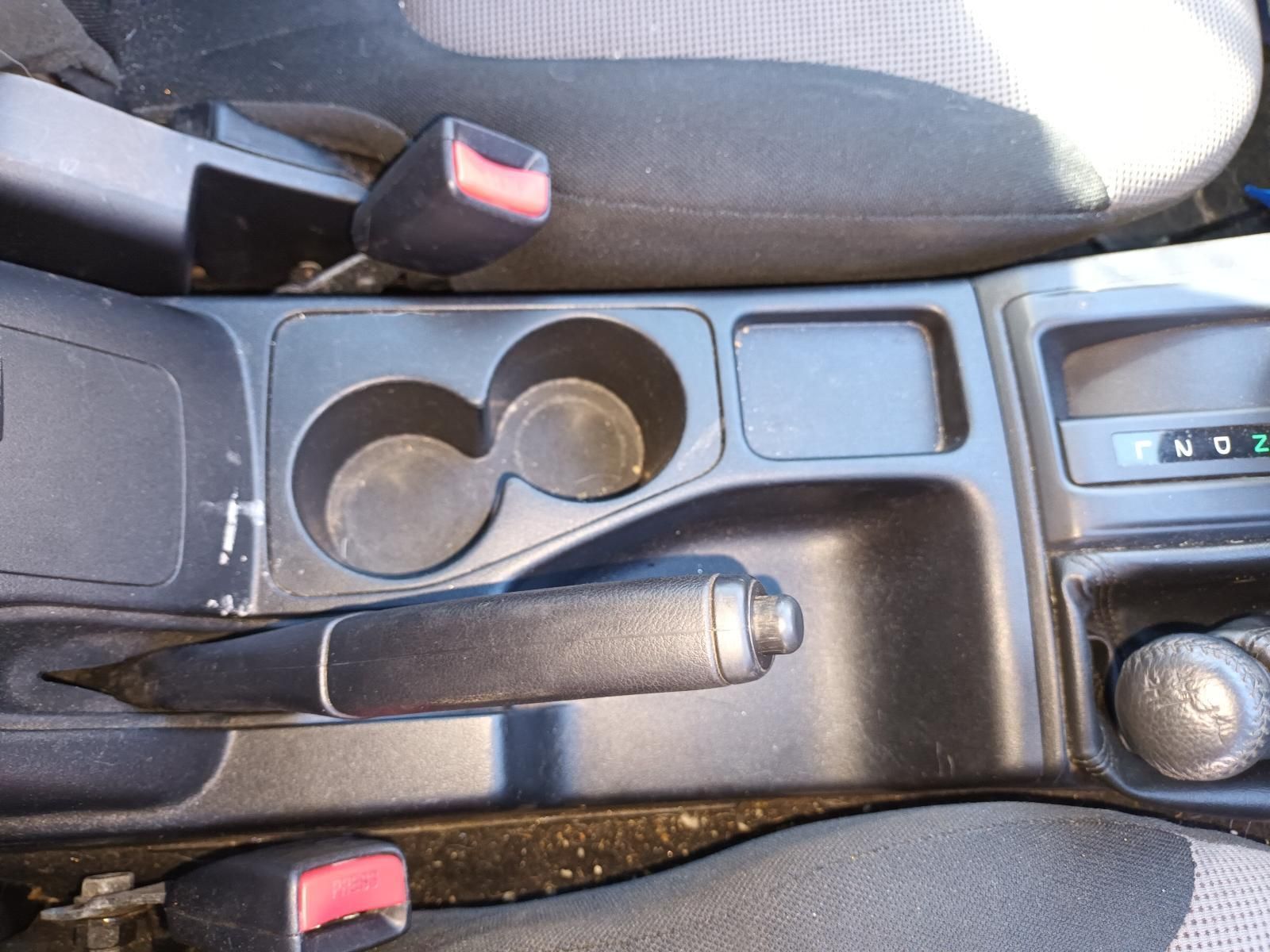 A Car Console with Two Cup Holders and a Handbrake — South West 4WD Wreckers In Brisbane, QLD
