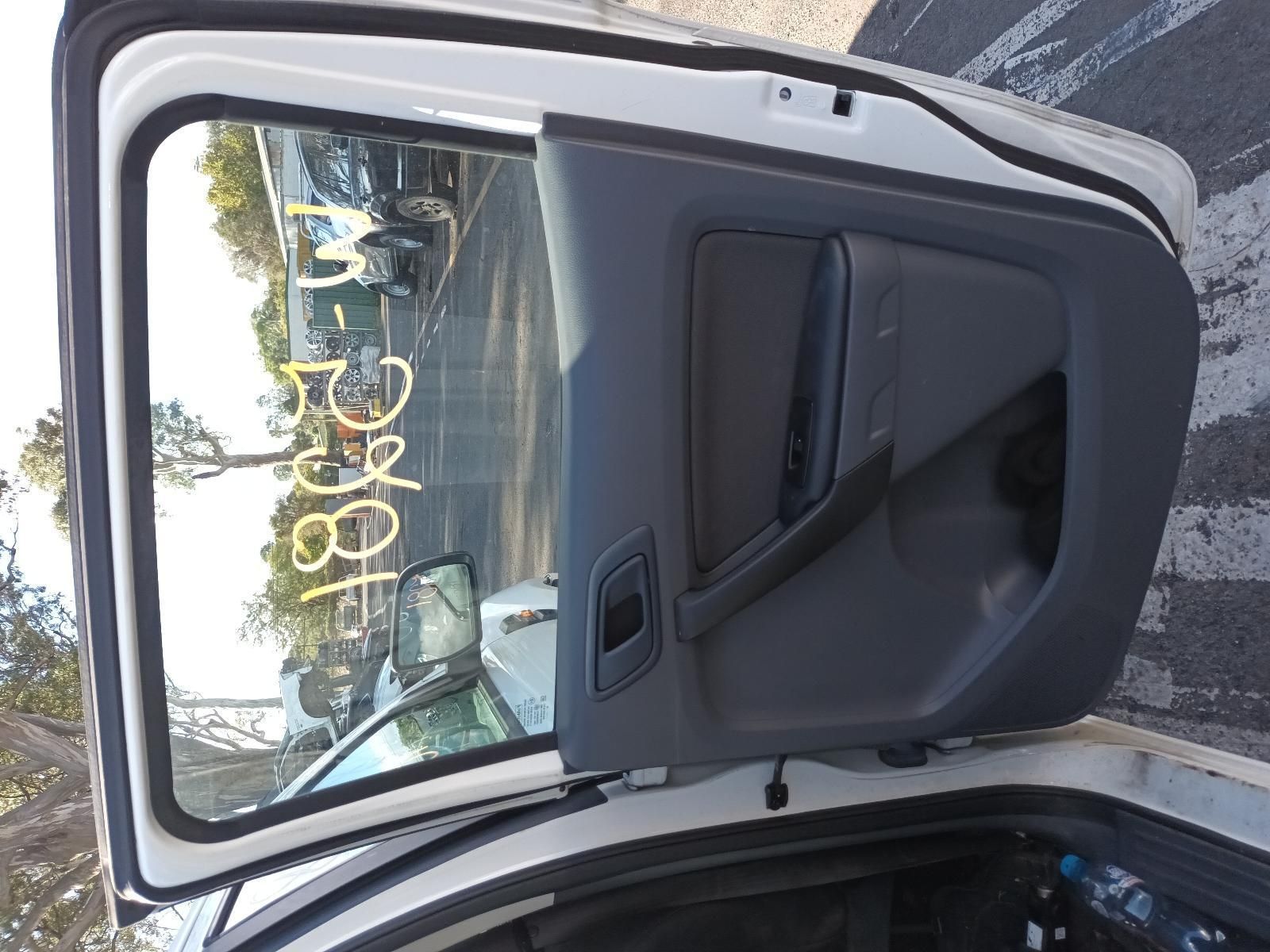 A White Car is Parked in a Parking Lot with the Door Open — South West 4WD Wreckers In Brisbane, QLD