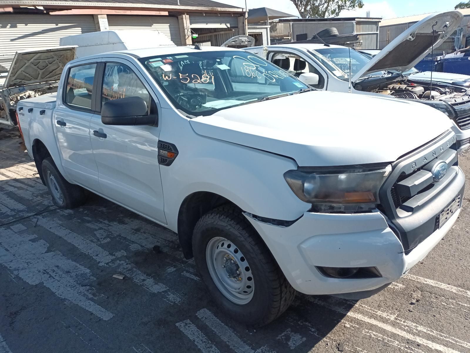 A White Truck with the Hood Up is Parked in a Parking Lot — South West 4WD Wreckers In Brisbane, QLD
