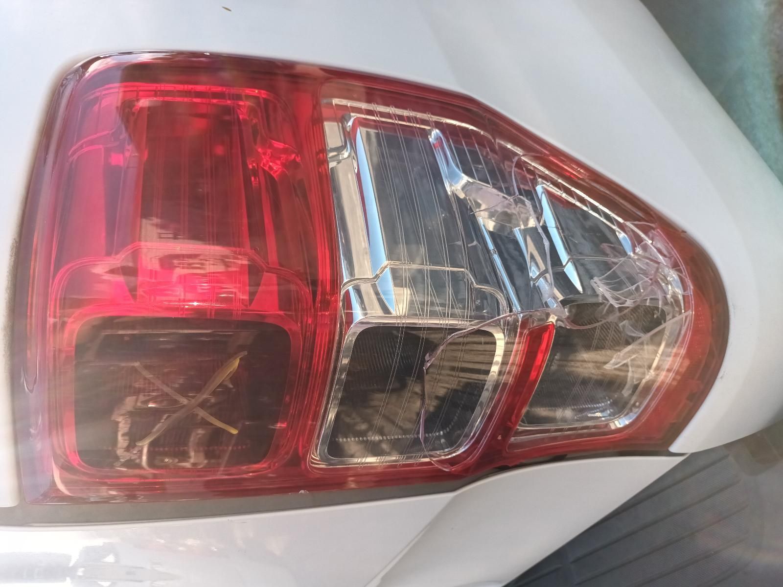 A Close Up of a Broken Tail Light on a White Car — South West 4WD Wreckers In Brisbane, QLD