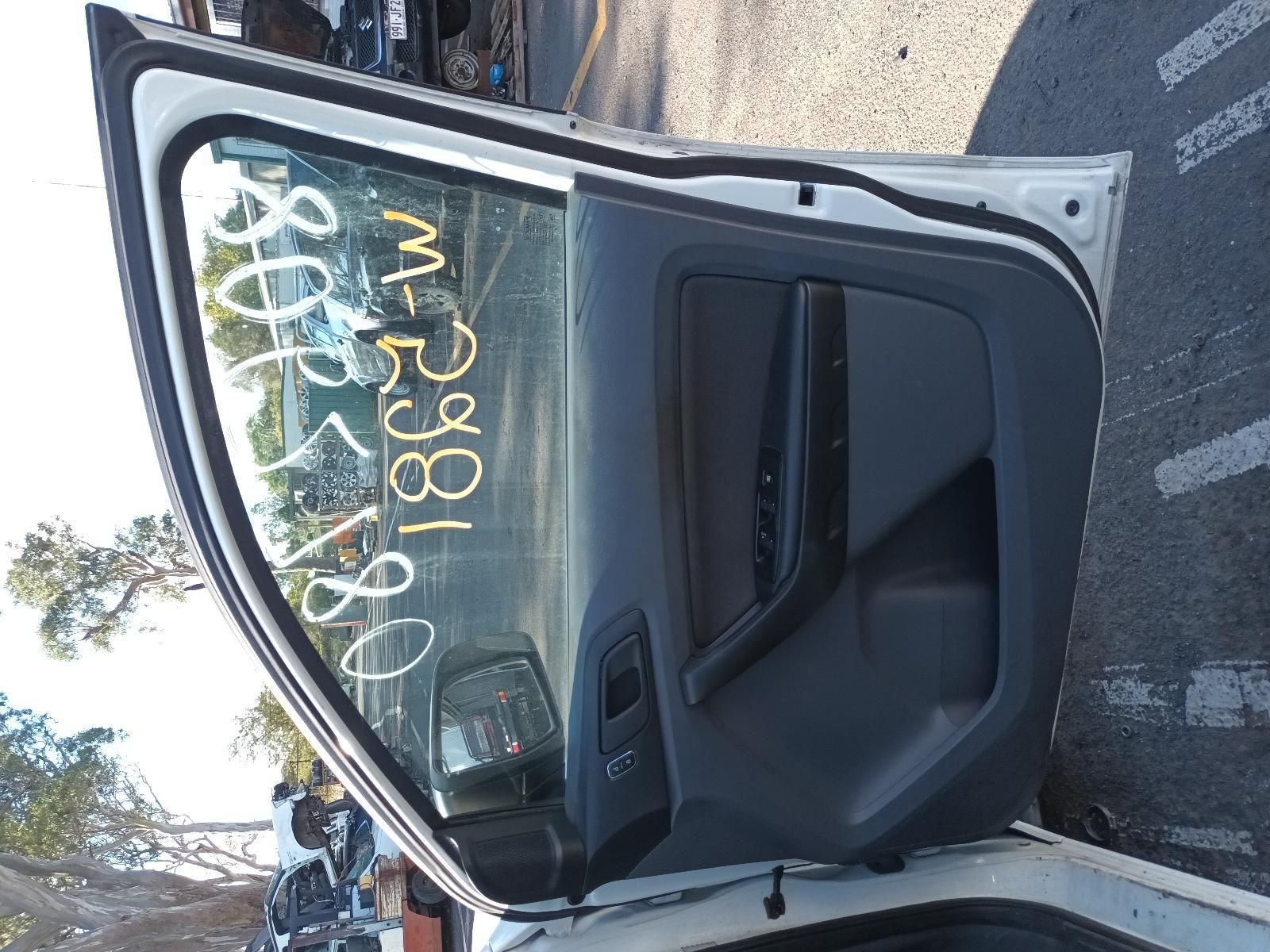 A White Car with the Door Open Has a Written Numbers on the Window — South West 4WD Wreckers In Brisbane, QLD