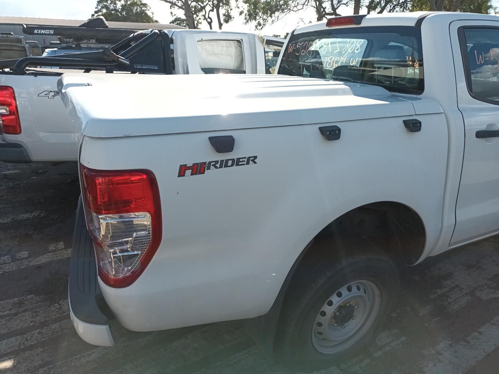 A White Ford Ranger Truck is Parked in a Parking Lot— South West 4WD Wreckers In Brisbane, QLD