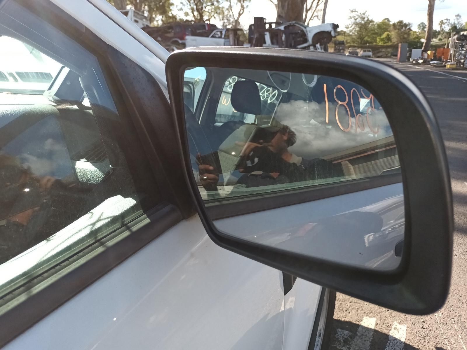A Side View Mirror on a White Car — South West 4WD Wreckers In Brisbane, QLD