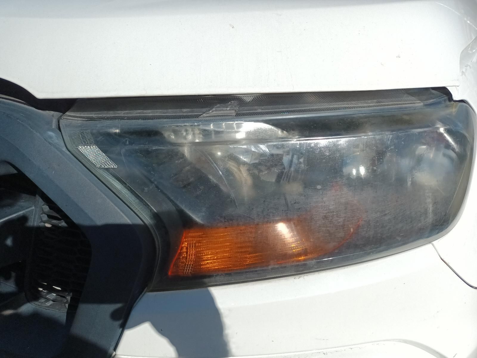 A Close Up of a White Car's Headlight — South West 4WD Wreckers In Brisbane, QLD