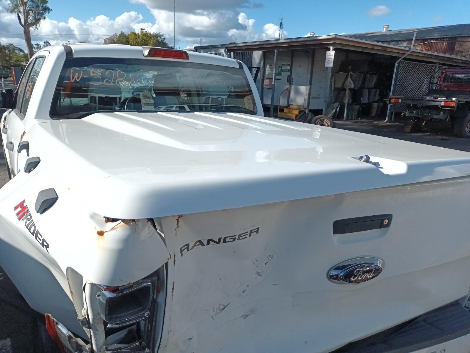 A White Truck with a White Bed Cover is Parked in a Parking Lot — South West 4WD Wreckers In Brisbane, QLD