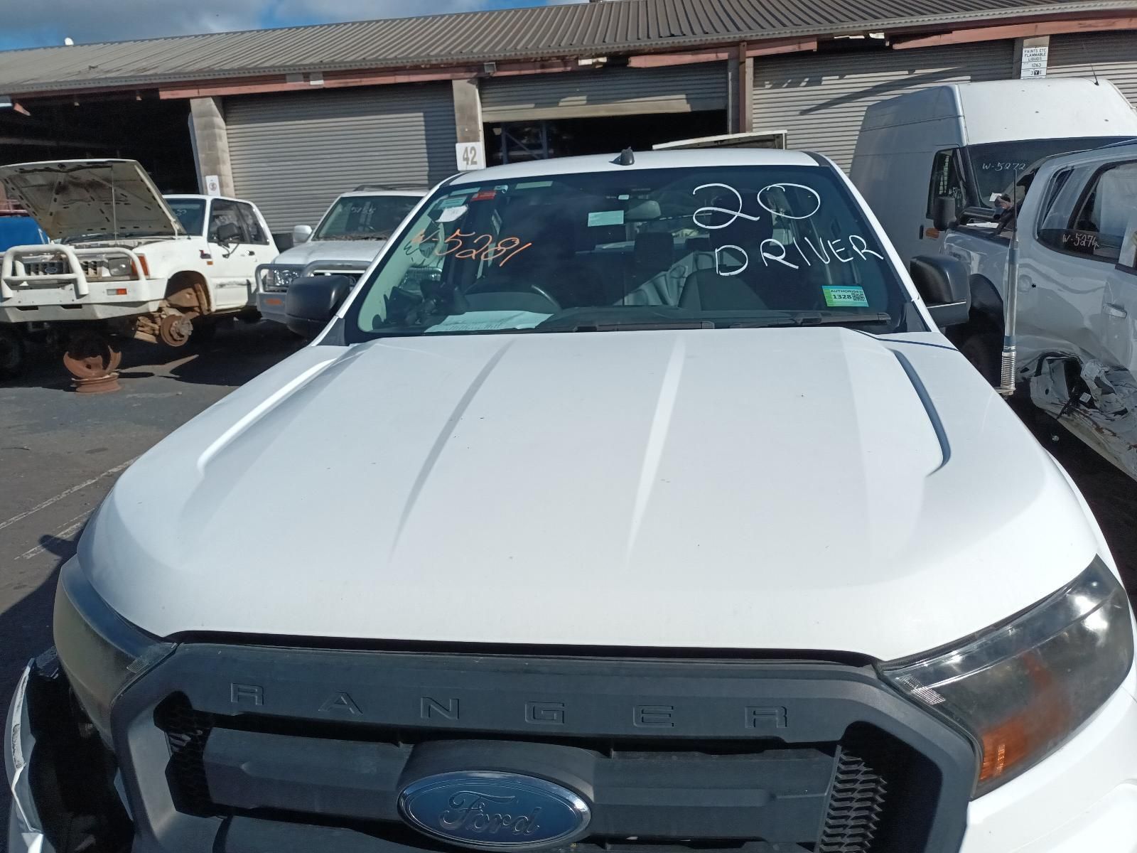 A White Ford Truck is Parked in a Parking Lot — South West 4WD Wreckers In Brisbane, QLD