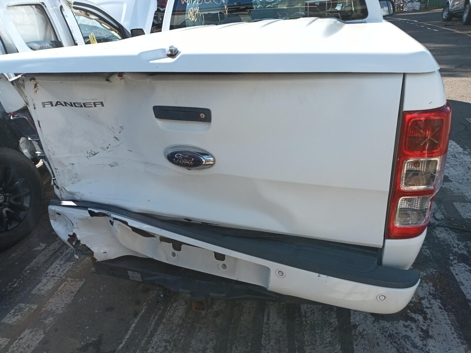 The Back End of a White Ford Ranger Pickup Truck is Damaged — South West 4WD Wreckers In Brisbane, QLD