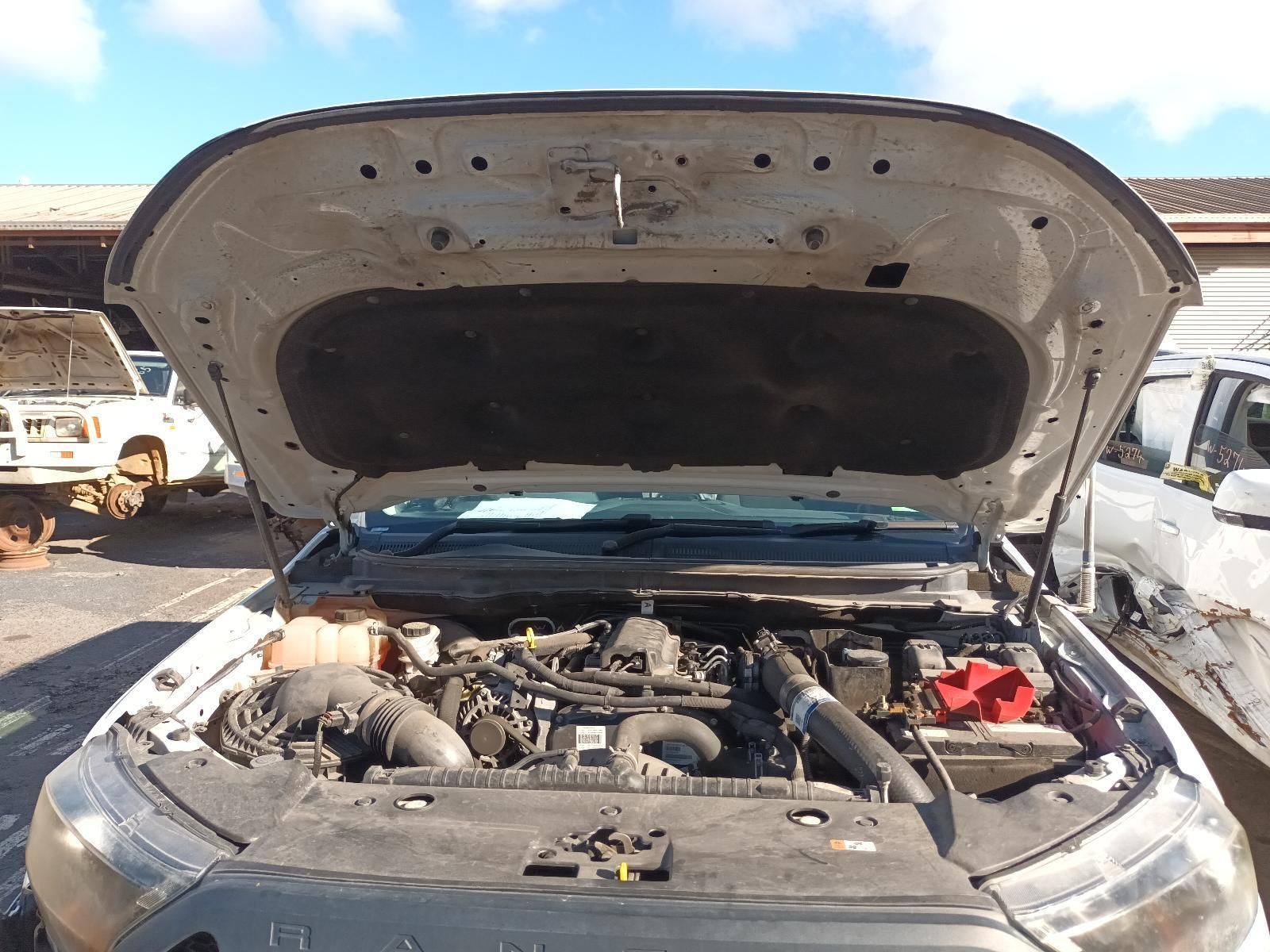 The Hood of a White Truck is Open and the Engine is Visible — South West 4WD Wreckers In Brisbane, QLD
