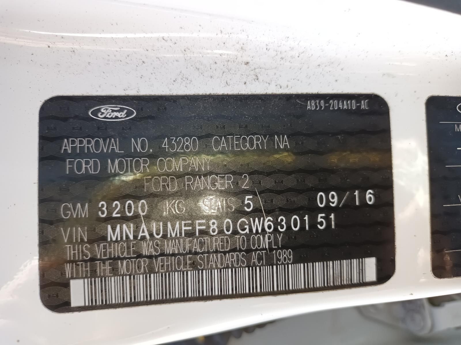 A White Ford Car with a License Plate — South West 4WD Wreckers In Brisbane, QLD