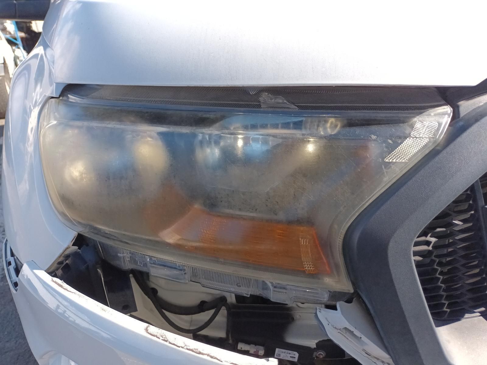 A Close Up of a Car's Headlight with a Broken Bumper — South West 4WD Wreckers In Brisbane, QLD
