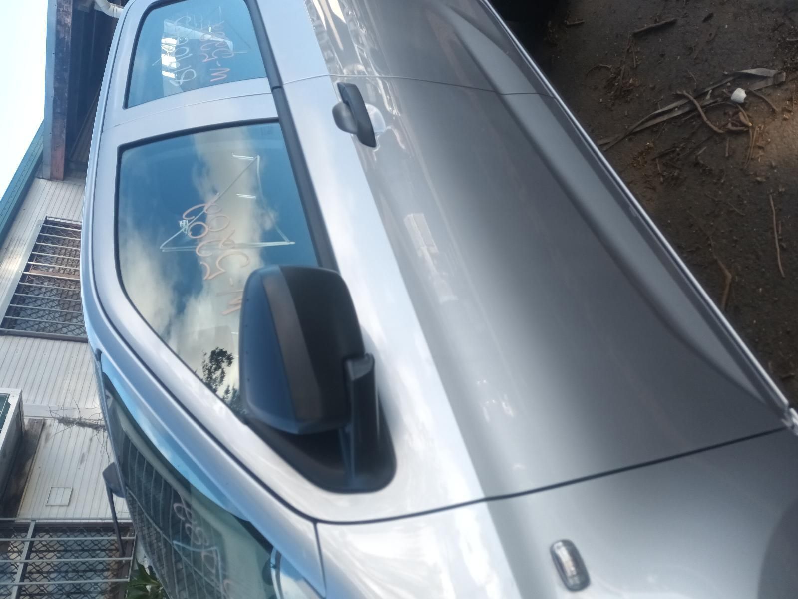 A Silver Car is Parked in Front of a Building — South West 4WD Wreckers In Brisbane, QLD