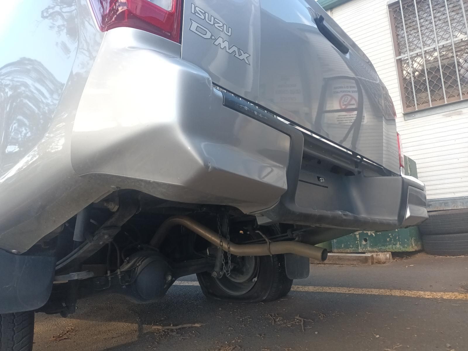 A Silver Car with a Damaged Bumper is Parked in a Parking Lot — South West 4WD Wreckers In Brisbane, QLD