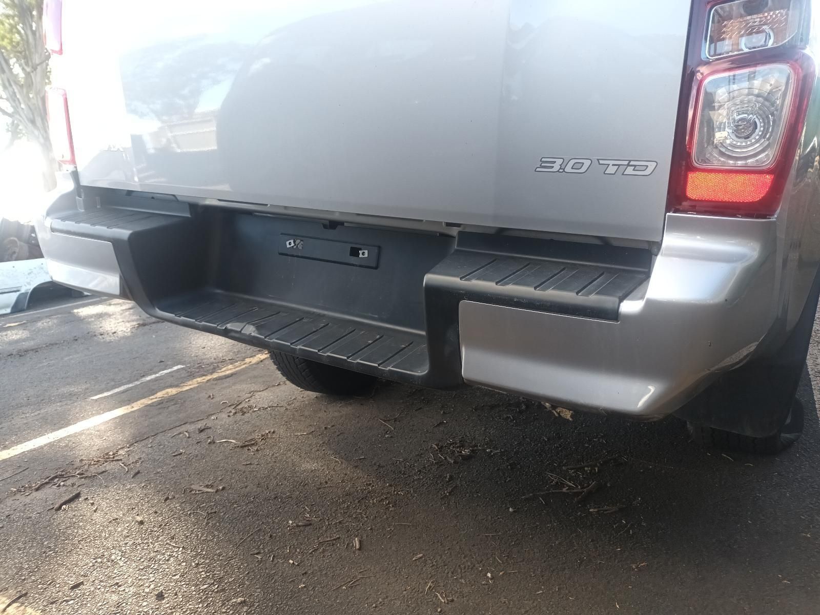 A Silver Pickup Truck is Parked on the Side of the Road — South West 4WD Wreckers In Brisbane, QLD