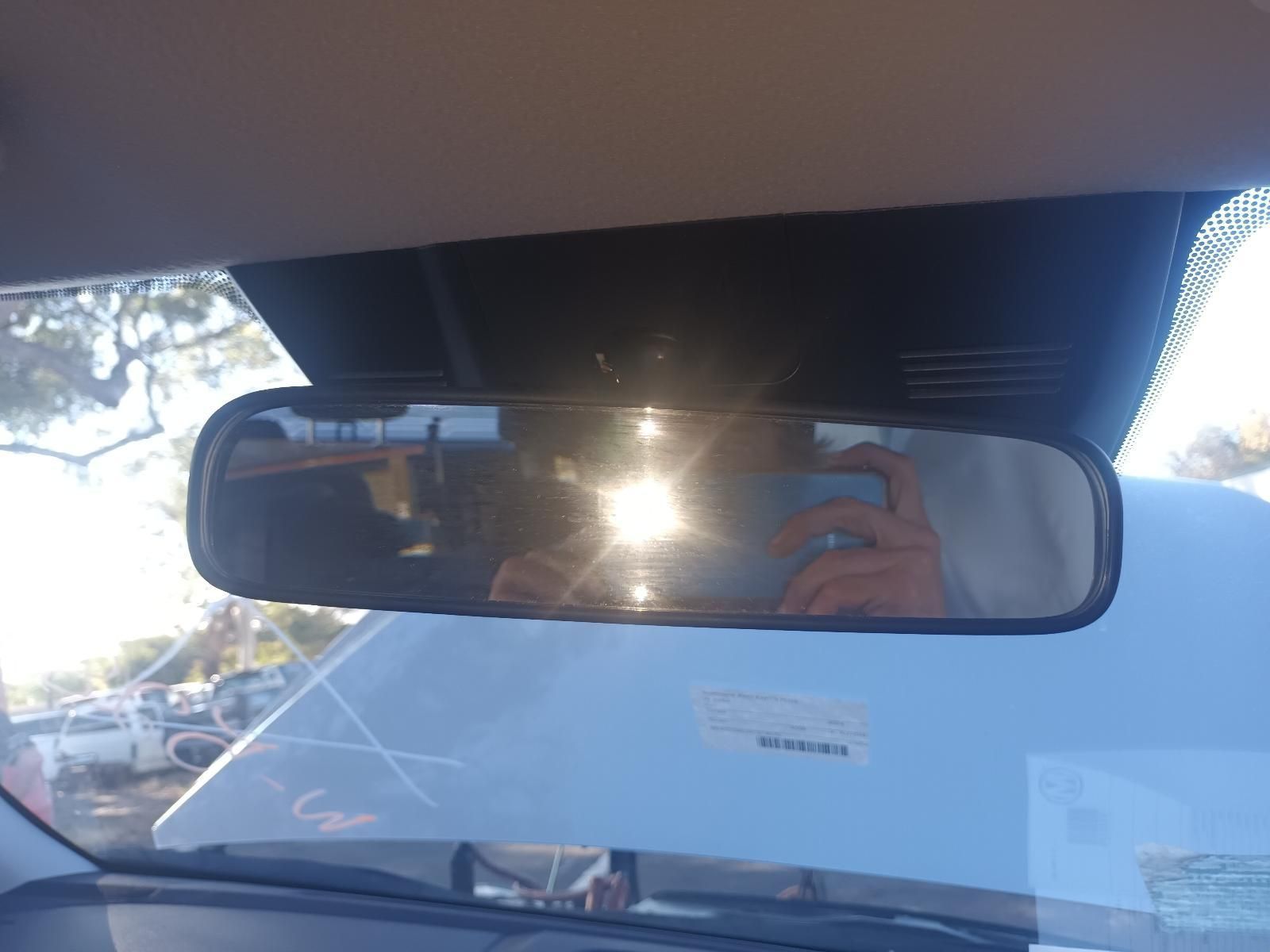 A Person is Taking a Picture of Themselves in the Rear View Mirror of a Car — South West 4WD Wreckers In Brisbane, QLD