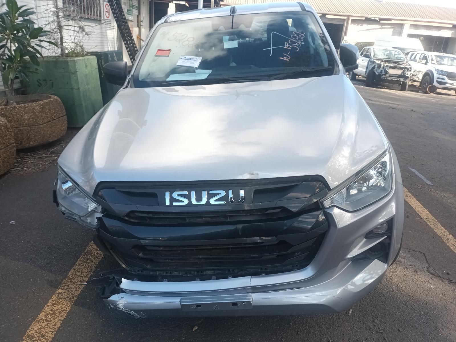 A Silver Isuzu Truck is Parked in a Parking Lot — South West 4WD Wreckers In Brisbane, QLD
