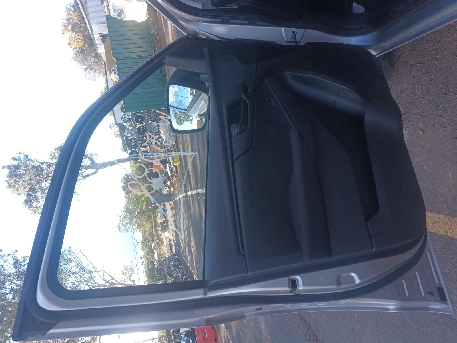 A Car with the Door Open is Parked on the Side of the Road — South West 4WD Wreckers In Brisbane, QLD