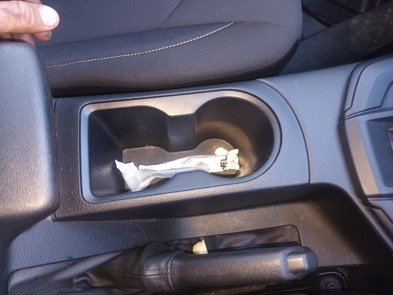 A Person is Holding a Cup Holder in a Car — South West 4WD Wreckers In Brisbane, QLD 