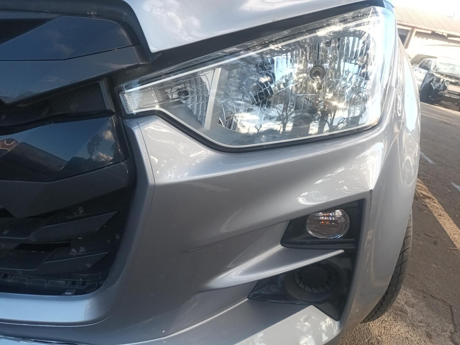 A Close Up of a Silver Car 's Headlight in a Parking Lot — South West 4WD Wreckers In Brisbane, QLD