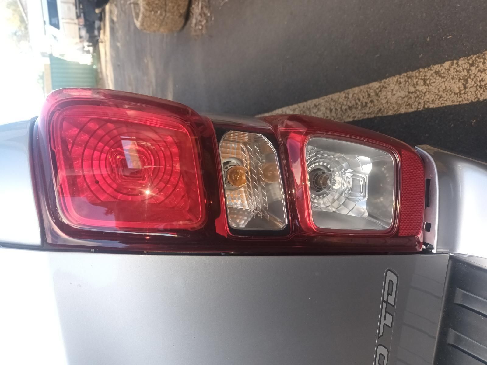 A Close Up of a Car 's Tail Light in a Parking Lot — South West 4WD Wreckers In Brisbane, QLD