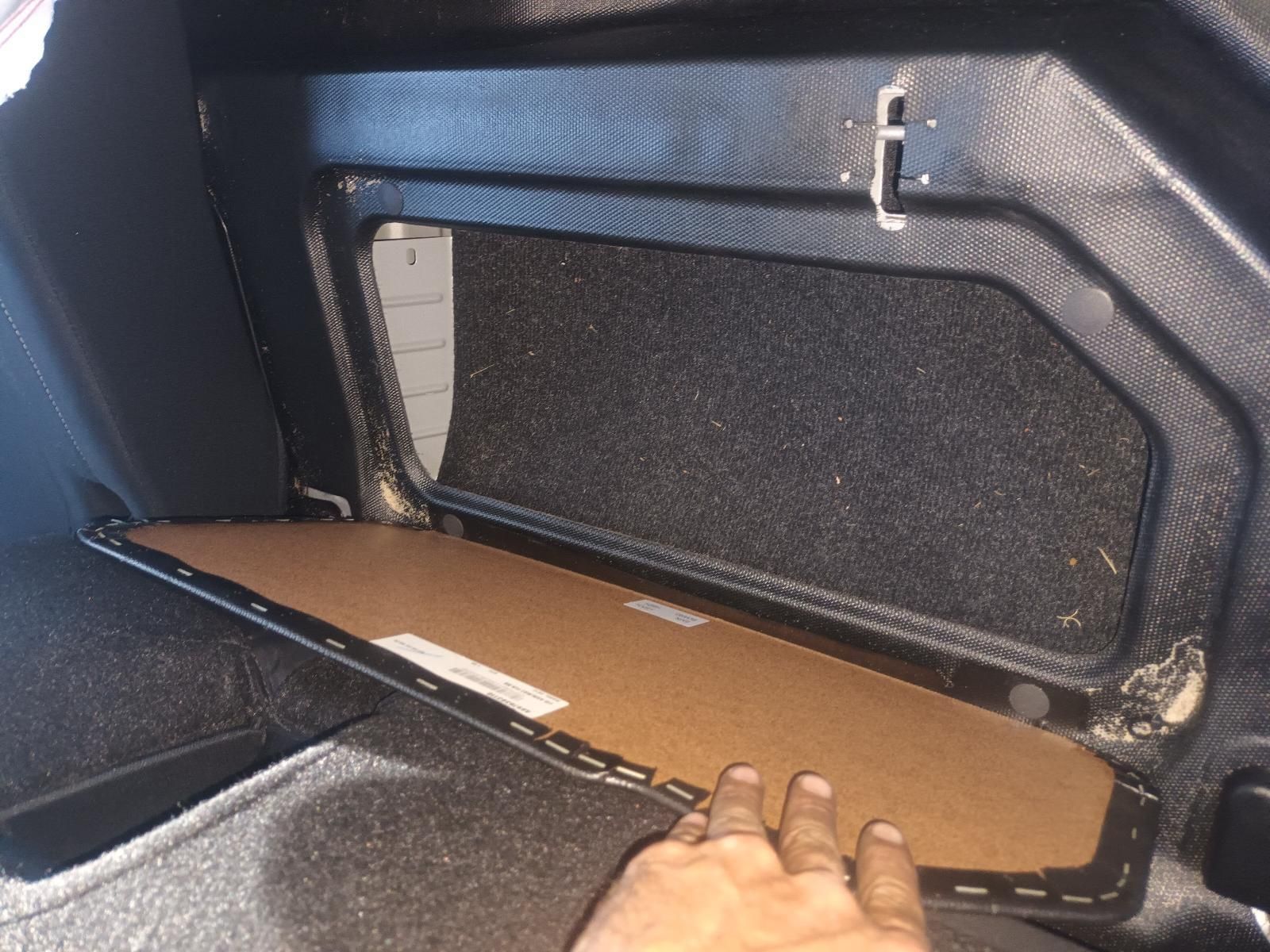 A Person is Holding a Piece of Cardboard in a Car Trunk — South West 4WD Wreckers In Brisbane, QLD