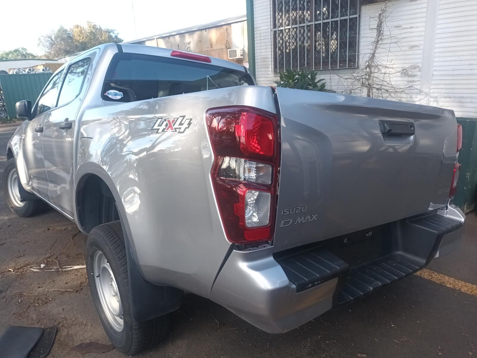 A Silver Pickup Truck is Parked in Front of a Building — South West 4WD Wreckers In Brisbane, QLD