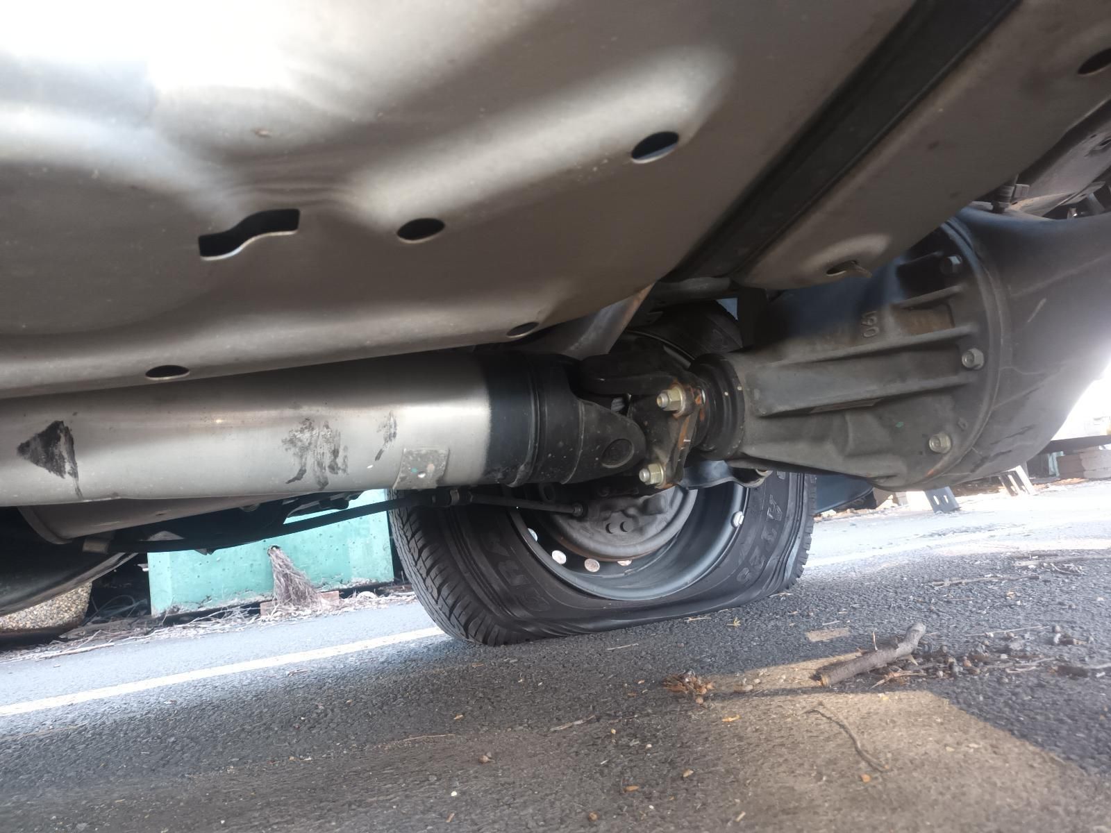 A Close Up of the Underside of a Car with a Tire on the Ground — South West 4WD Wreckers In Brisbane, QLD