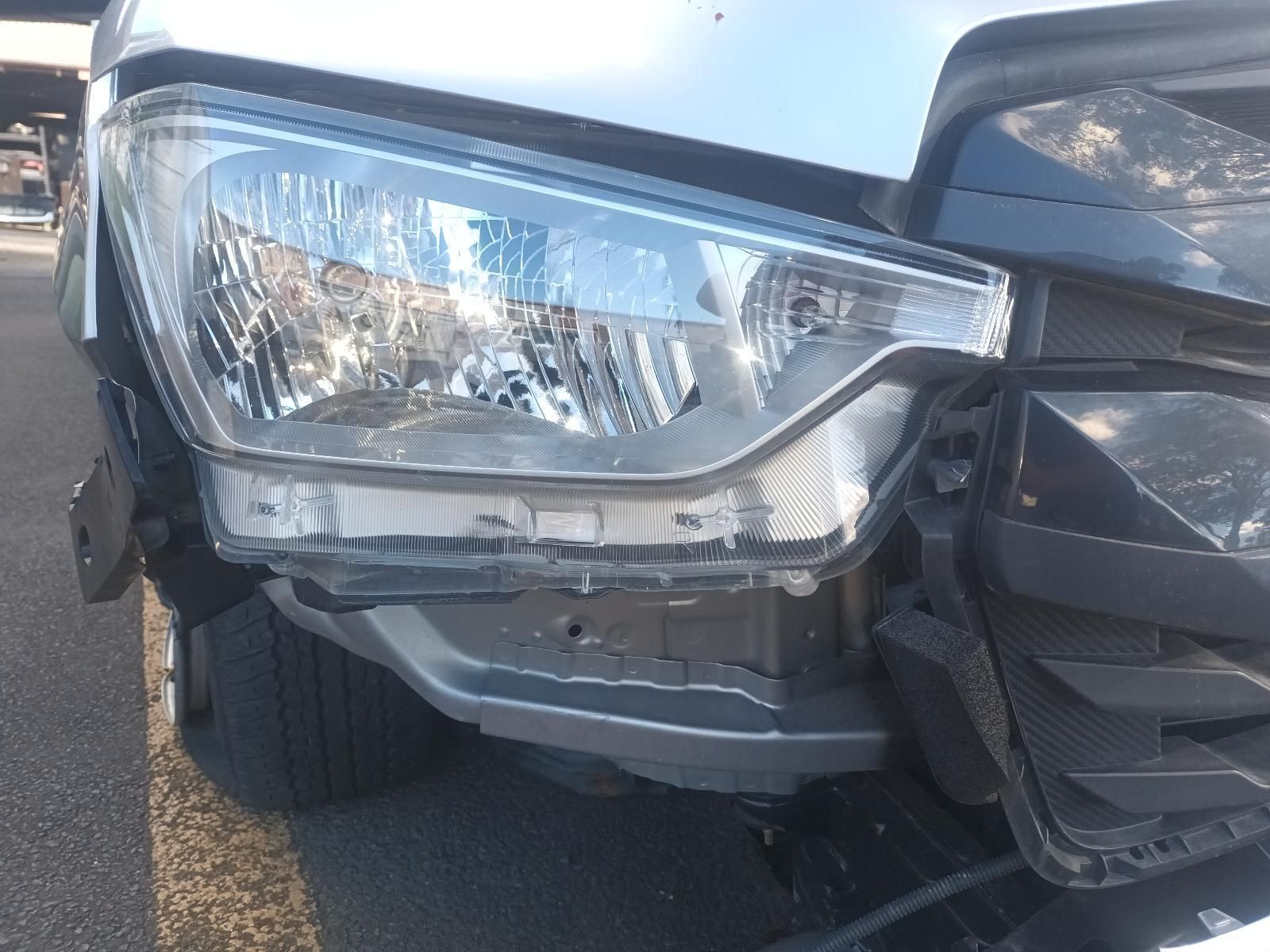 A Car with a Broken Headlight is Parked on the Side of the Road — South West 4WD Wreckers In Brisbane, QLD