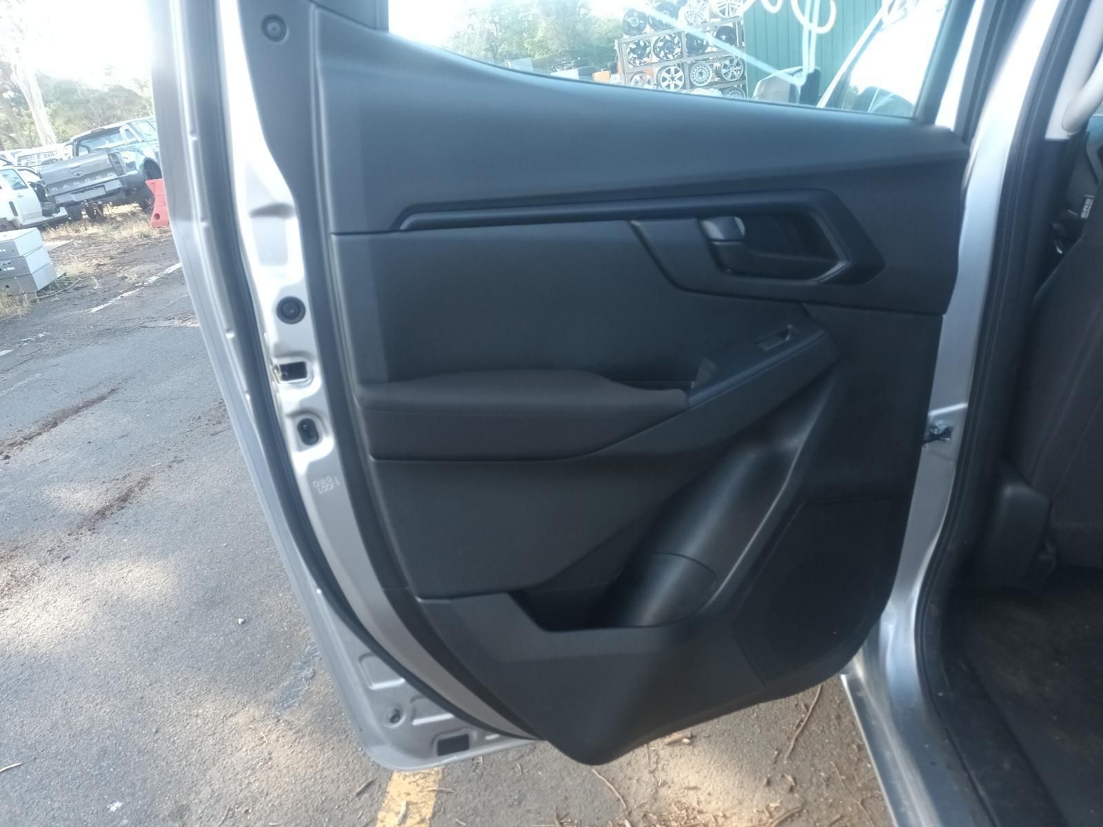 A Silver Car with the Door Open is Parked on the Side of the Road — South West 4WD Wreckers In Brisbane, QLD