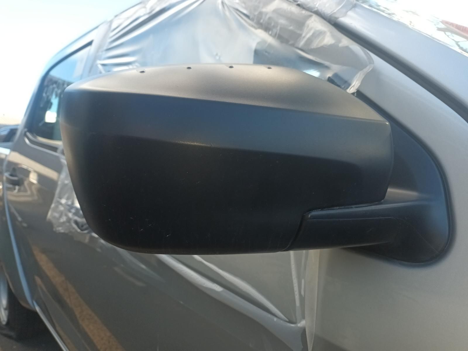 A Side View Mirror on a Car is Wrapped in Plastic — South West 4WD Wreckers In Brisbane, QLD