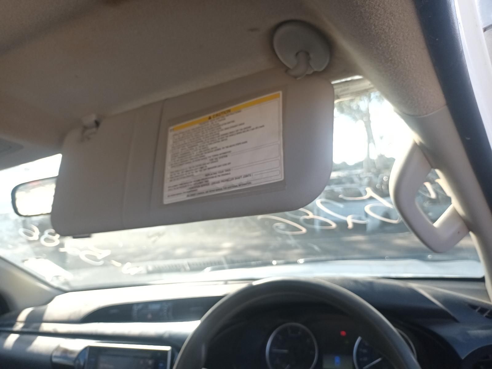 A Sun Visor in a Car with a Warning Label on It — South West 4WD Wreckers In Brisbane, QLD