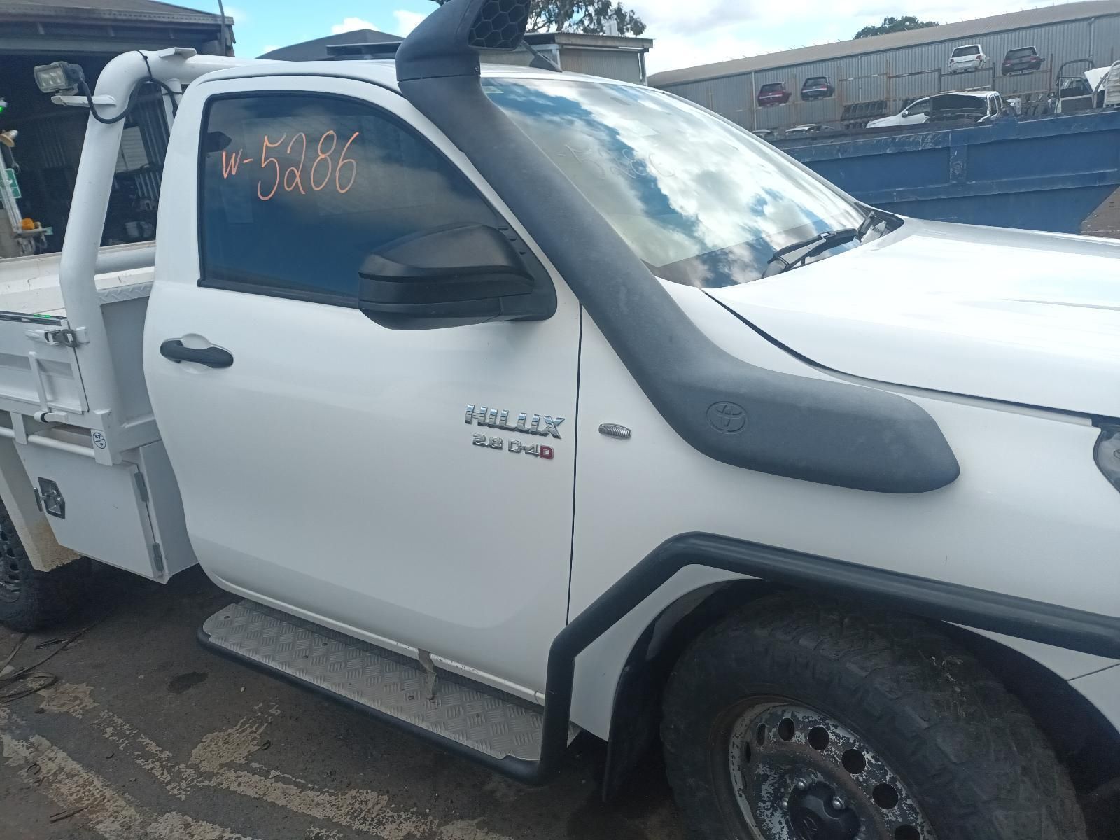 A White Truck with a Snorkel on the Hood is Parked in a Parking Lot — South West 4WD Wreckers In Brisbane, QLD