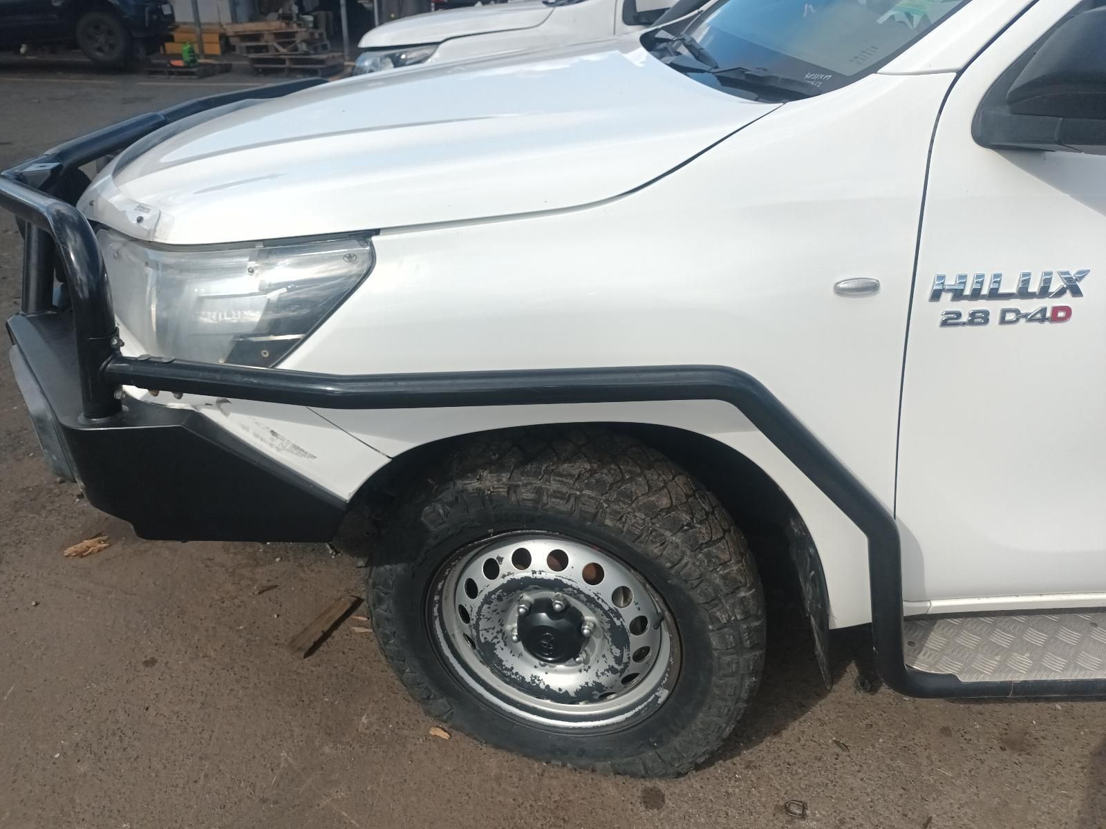 A White Hilux Truck is Parked in a Parking Lot — South West 4WD Wreckers In Brisbane, QLD