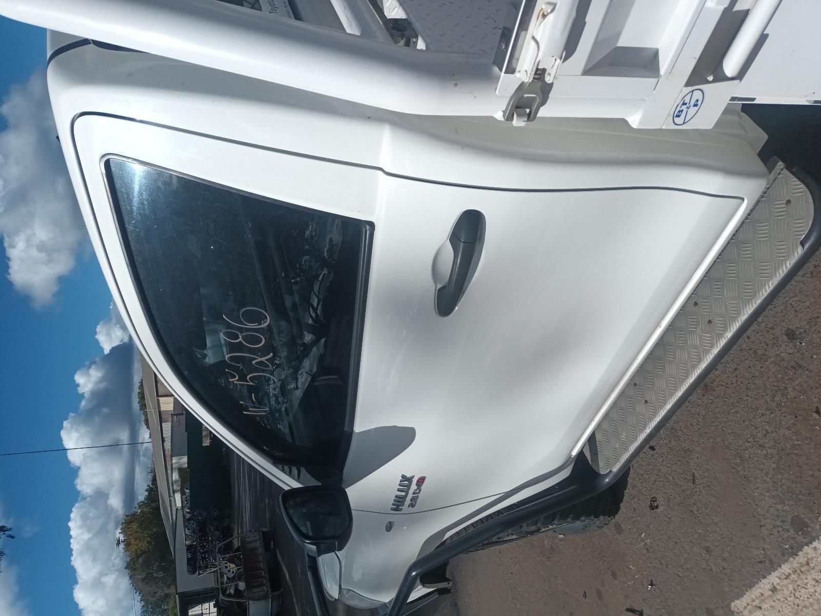 A White Car is Parked on the Side of the Road — South West 4WD Wreckers In Brisbane, QLD