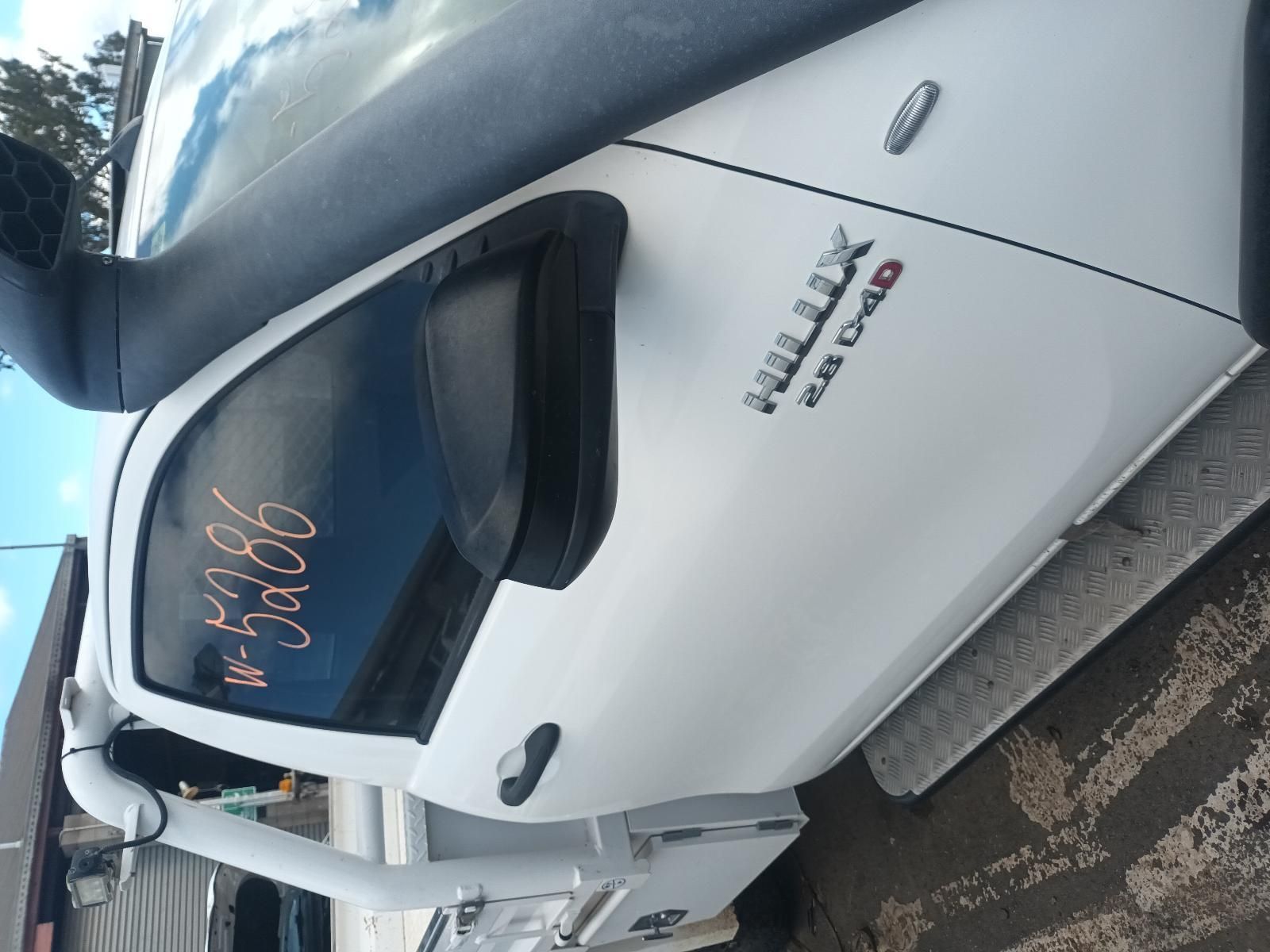 A White Hilux Truck is Parked on the Side of the Road — South West 4WD Wreckers In Brisbane, QLD