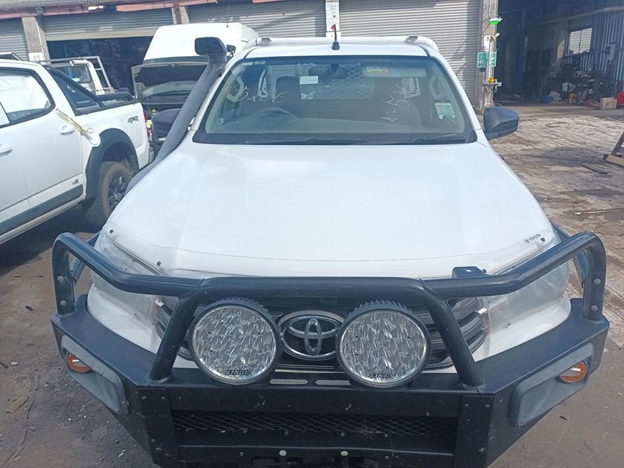 A White Truck with a Black Bumper is Parked in a Parking Lot — South West 4WD Wreckers In Brisbane, QLD