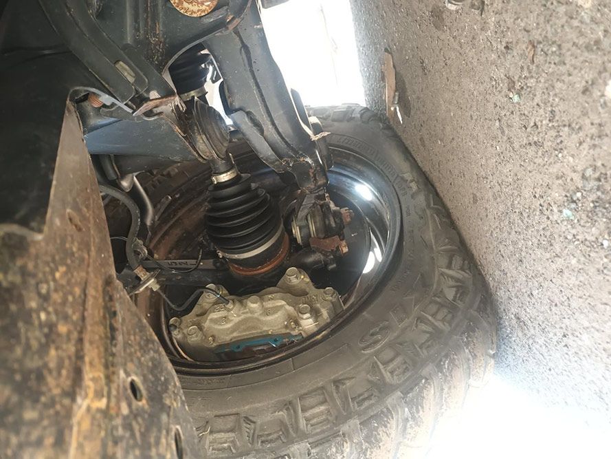 A Close Up of the Underside of a Car with a Tire — South West 4WD Wreckers In Brisbane, QLD