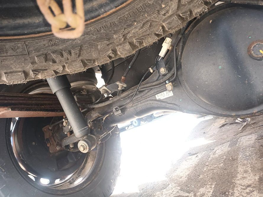 A Close Up of the Underside of a Car with a Tire and Shock Absorber — South West 4WD Wreckers In Brisbane, QLD